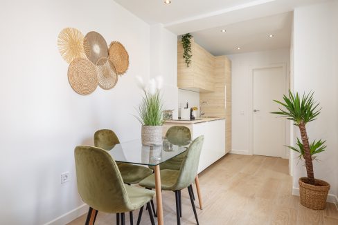 Tastefully decorated dining area and kitchen of centrally located apartment in Malaga city.