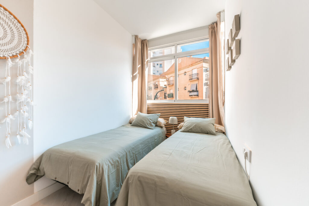 Second bedroom with 2 single beds and exterior view of apartment in Malaga centre