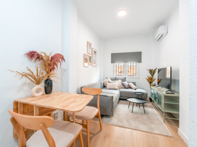 Living room with dining area of cosy apartment with patio in Malaga