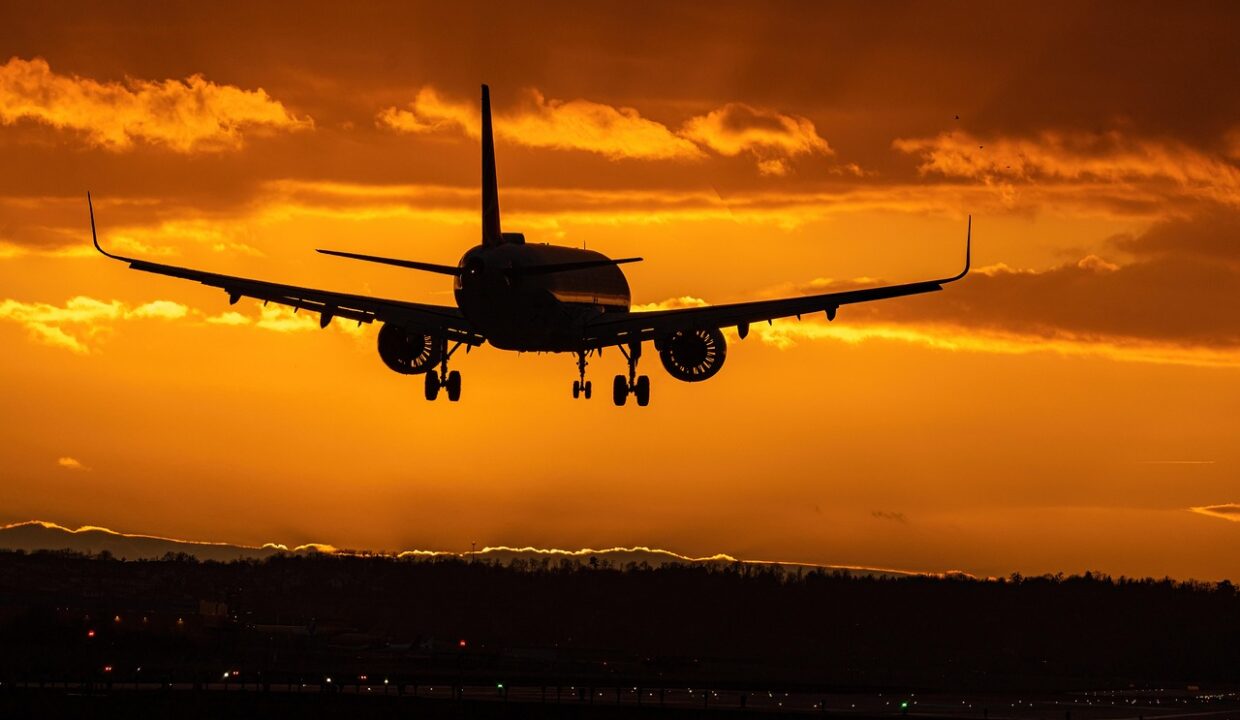 Flying airplane sunset